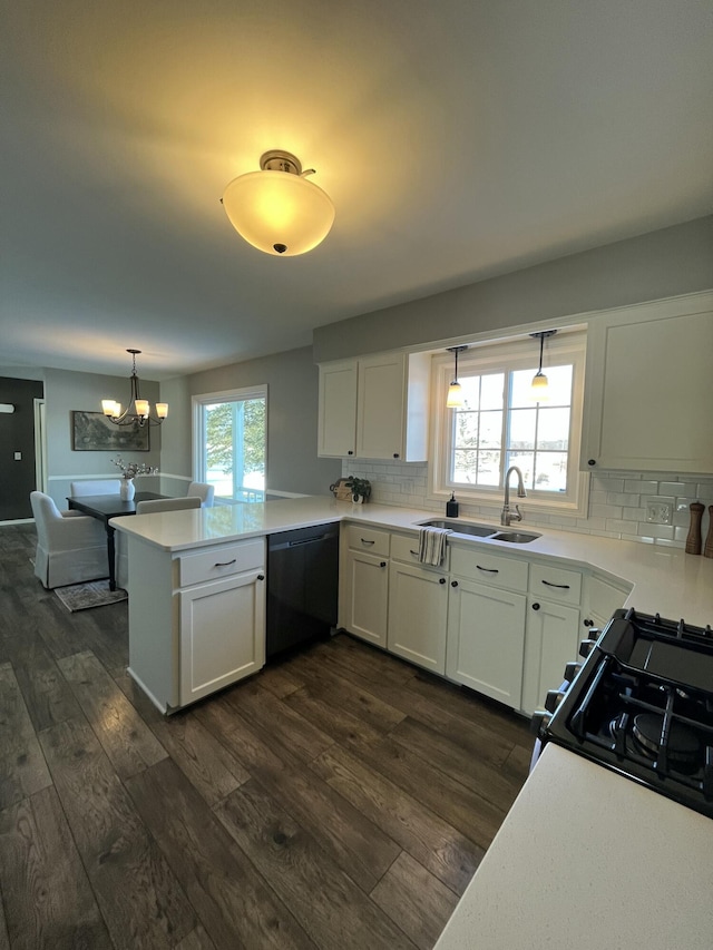 kitchen with dark wood-type flooring, sink, kitchen peninsula, dishwasher, and white cabinets