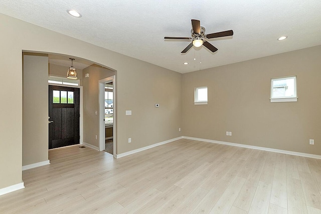 entryway featuring ceiling fan, a textured ceiling, and light wood-type flooring