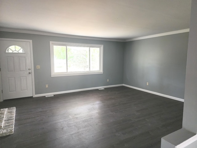 entryway featuring dark hardwood / wood-style floors, ornamental molding, and a wealth of natural light