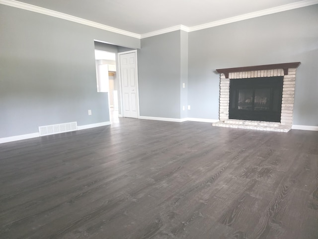 unfurnished living room featuring crown molding, dark wood-type flooring, and a brick fireplace