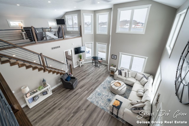 living room with a high ceiling and hardwood / wood-style flooring