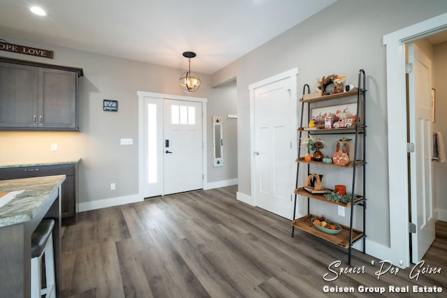 entrance foyer with a chandelier and dark hardwood / wood-style flooring