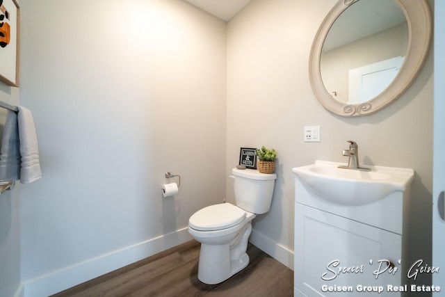 bathroom featuring hardwood / wood-style floors, vanity, and toilet