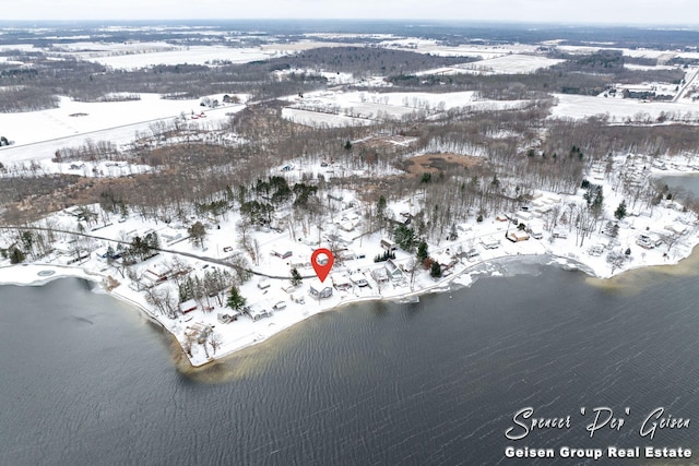 snowy aerial view featuring a water view