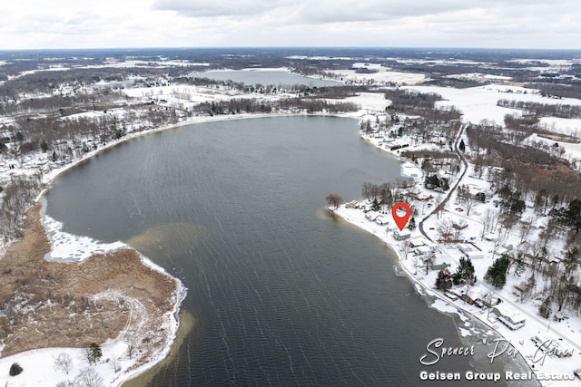 snowy aerial view featuring a water view