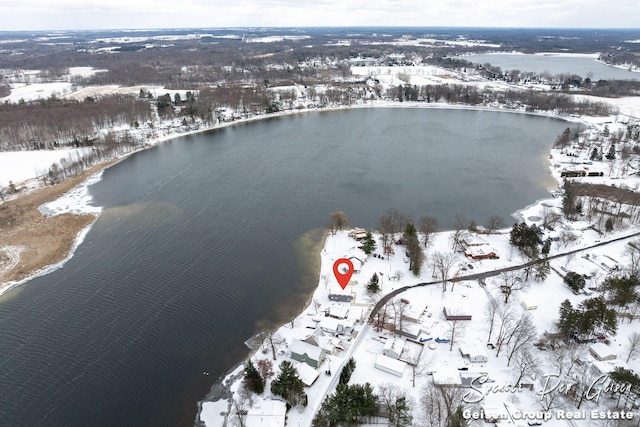 snowy aerial view featuring a water view