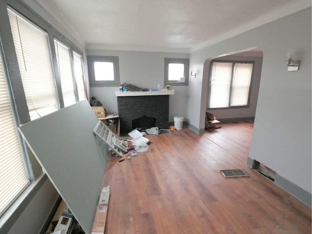 living room with wood-type flooring and a textured ceiling