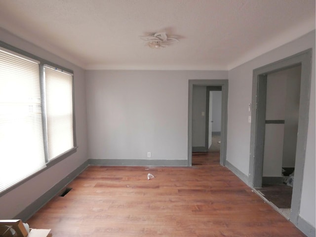 unfurnished room with light wood-type flooring