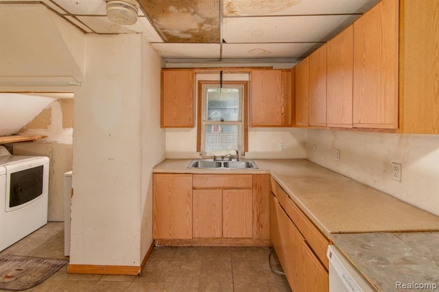 kitchen featuring washing machine and clothes dryer and sink