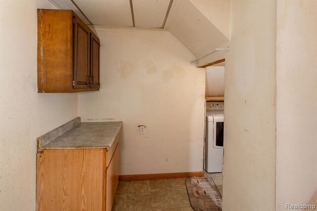 kitchen featuring washer / clothes dryer and a drop ceiling