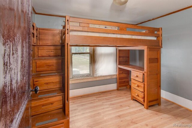 bedroom featuring light hardwood / wood-style flooring and ornamental molding