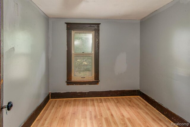 unfurnished room with wood-type flooring