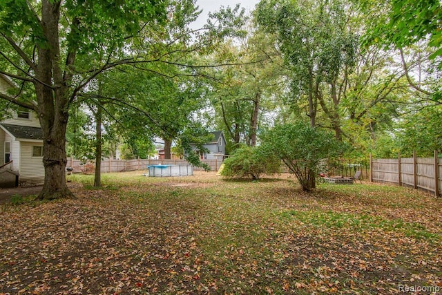 view of yard with a fenced in pool