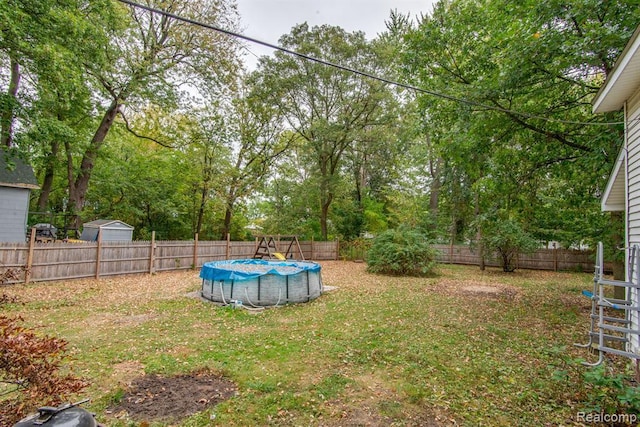 view of yard with a covered pool