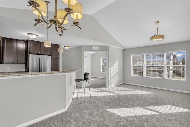 kitchen featuring high end fridge, light colored carpet, dark brown cabinetry, and a chandelier