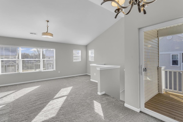 interior space with carpet, lofted ceiling, and a chandelier