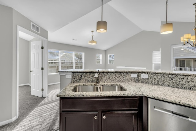 kitchen with carpet flooring, dishwasher, decorative light fixtures, and sink