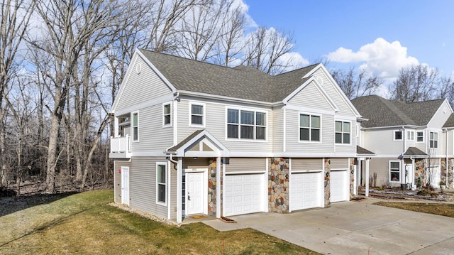 view of front facade with a front yard and a garage