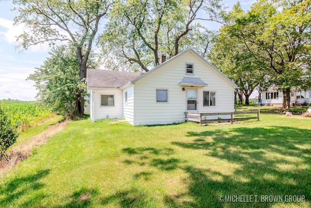 back of house with a lawn