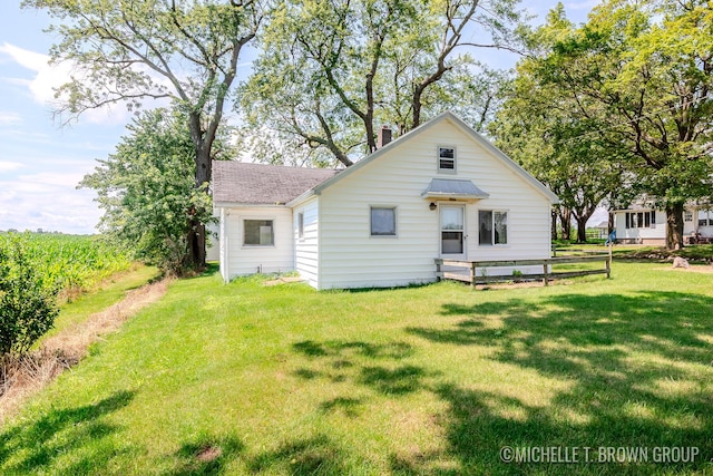 back of house featuring a yard