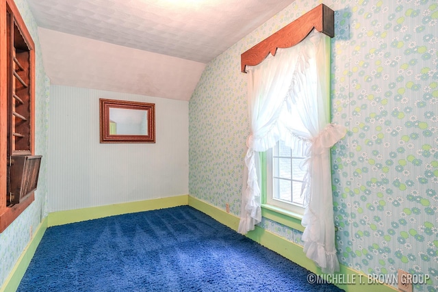 bonus room with carpet floors and vaulted ceiling