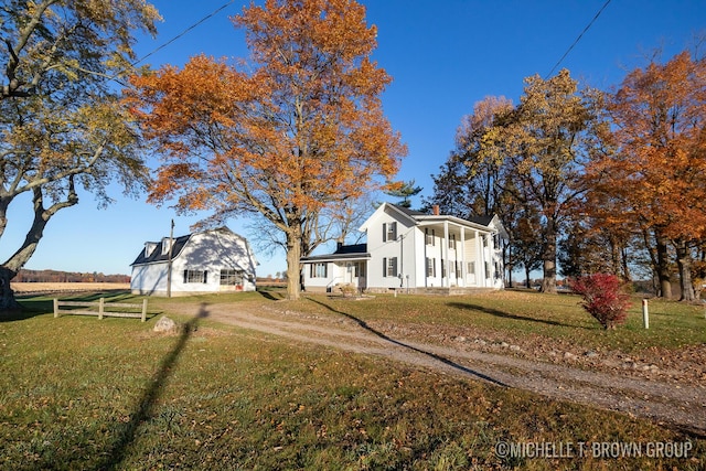 view of front of property featuring covered porch and a front yard