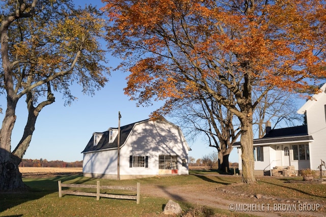 back of house with a lawn