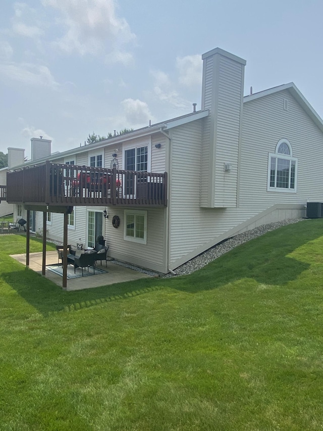 back of house with a lawn, central AC unit, a deck, and a patio