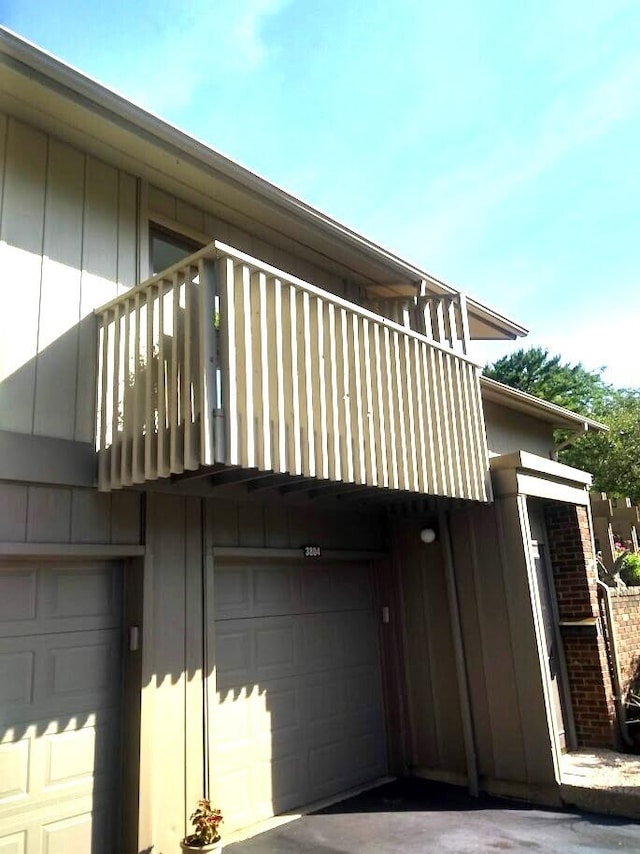 view of property exterior featuring a garage and a balcony