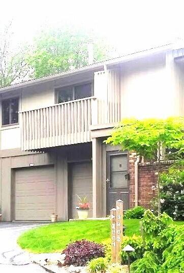 view of front of property with a balcony and a garage