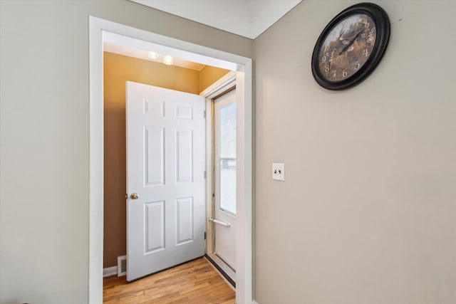 doorway to outside featuring a wealth of natural light and light hardwood / wood-style flooring