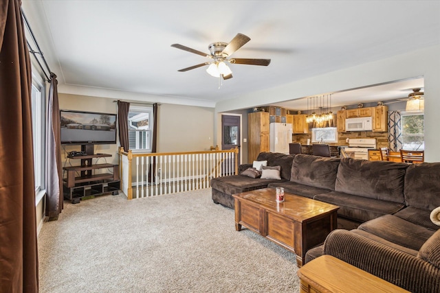 carpeted living room featuring ceiling fan