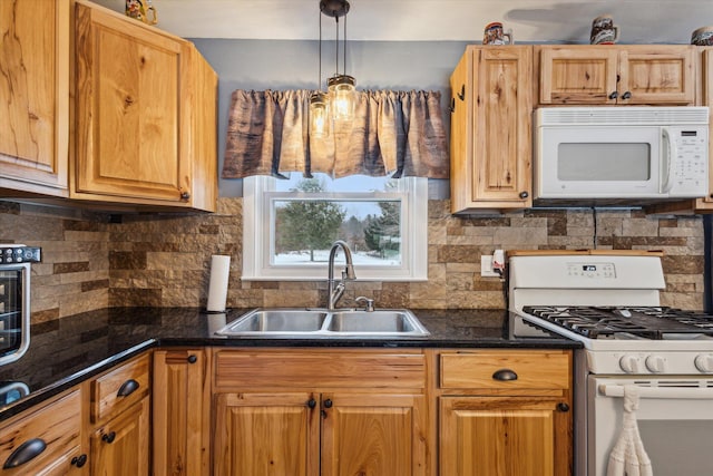 kitchen with backsplash, decorative light fixtures, white appliances, and sink