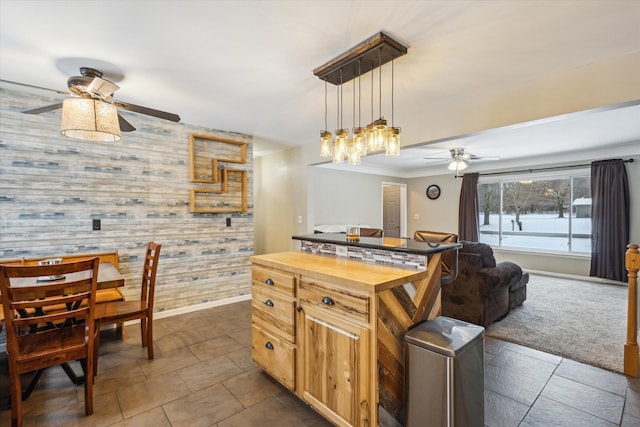 kitchen featuring wood counters, pendant lighting, ceiling fan, and wood walls