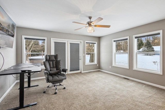 unfurnished office featuring carpet and ceiling fan