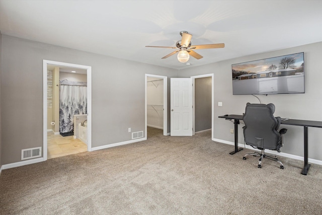 carpeted home office with ceiling fan