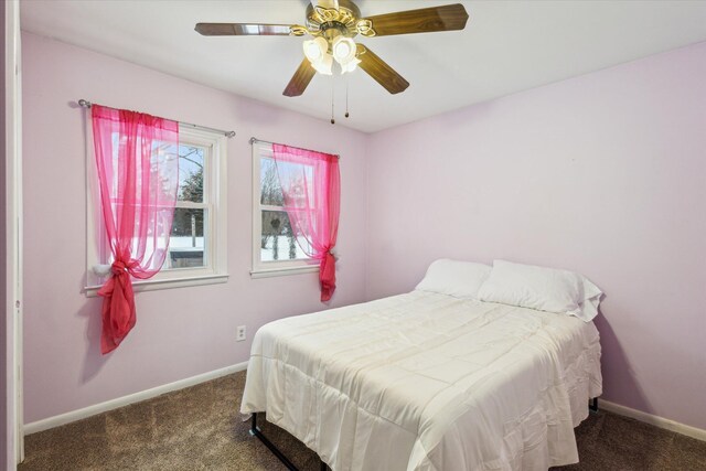 bedroom with ceiling fan and dark colored carpet