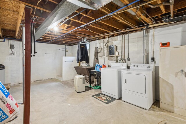 basement featuring separate washer and dryer and sink