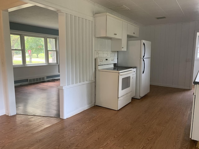 kitchen featuring white cabinets, hardwood / wood-style floors, white appliances, and baseboard heating