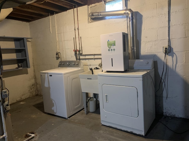 clothes washing area with washing machine and dryer