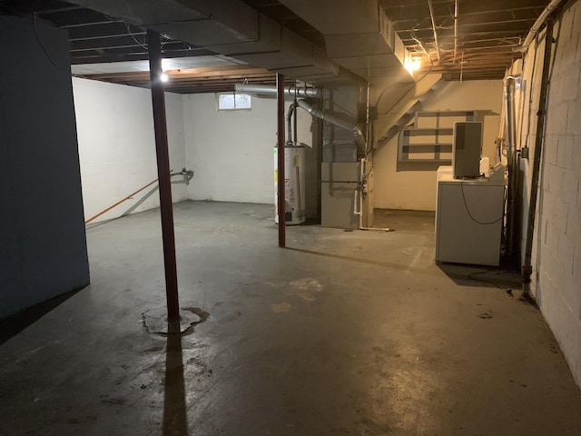 basement featuring gas water heater, washer / clothes dryer, and heating unit