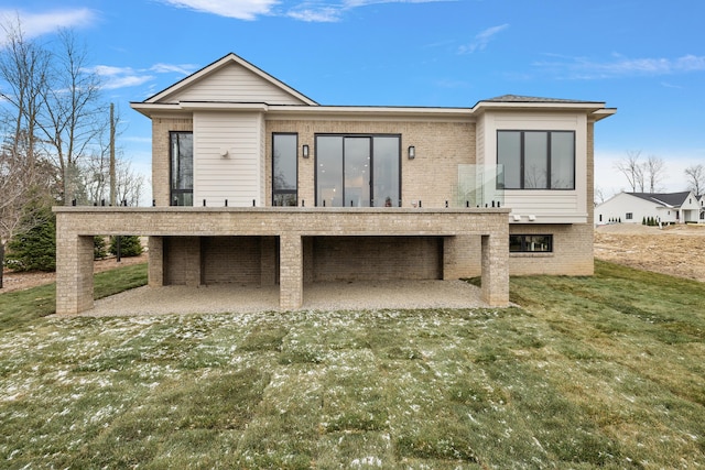 rear view of property featuring a lawn and a patio area