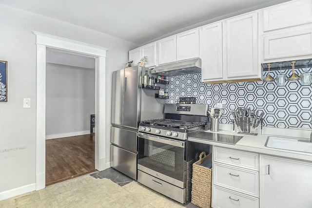 kitchen with stainless steel range with gas cooktop, sink, range hood, tasteful backsplash, and white cabinetry