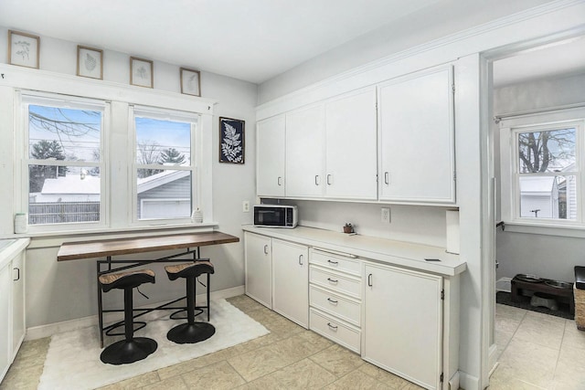 kitchen featuring white cabinets