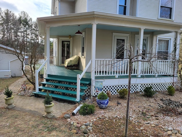 view of exterior entry with a porch