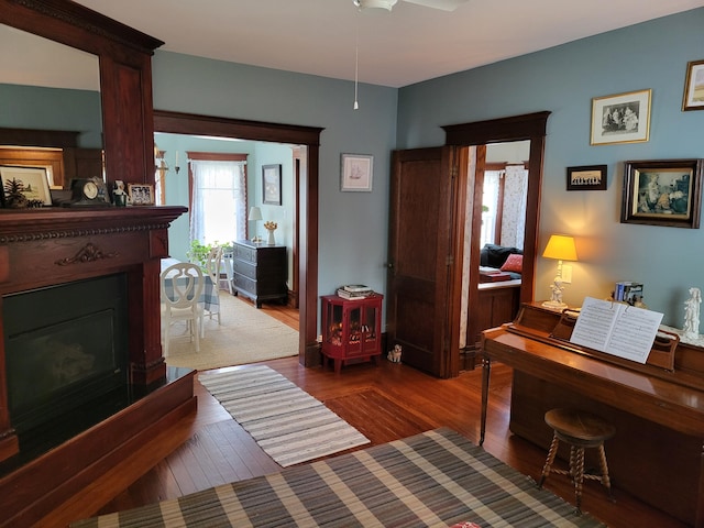 interior space with ceiling fan and dark wood-type flooring