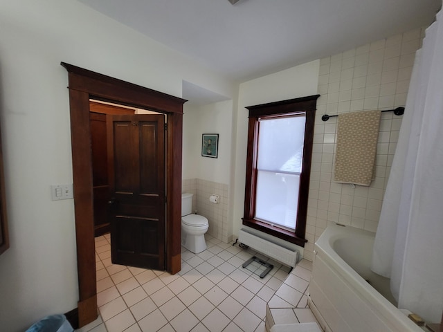 bathroom featuring tile patterned flooring, shower / bath combo, toilet, and tile walls