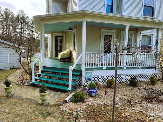 view of exterior entry with covered porch