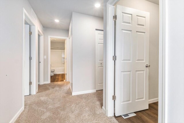 hallway with carpet floors