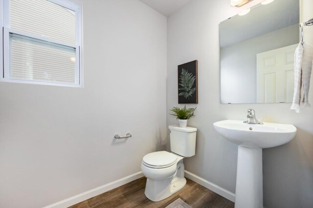 bathroom featuring hardwood / wood-style flooring, toilet, and sink